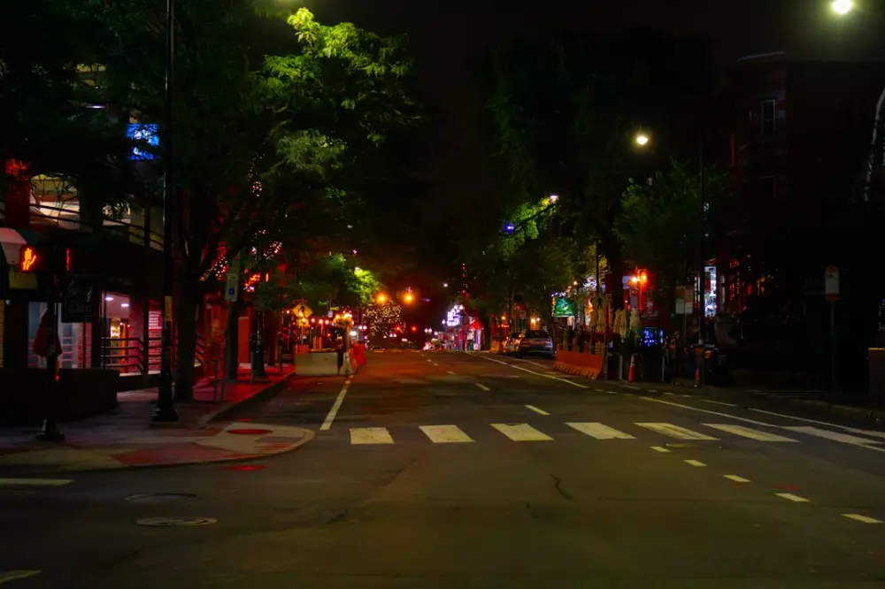 Urban street at night with glowing lights and crosswalk, illustrating everyday inspiration